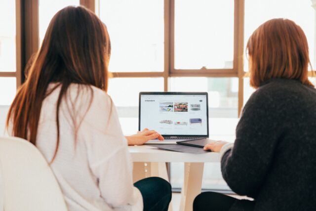 Two women looking at laptop