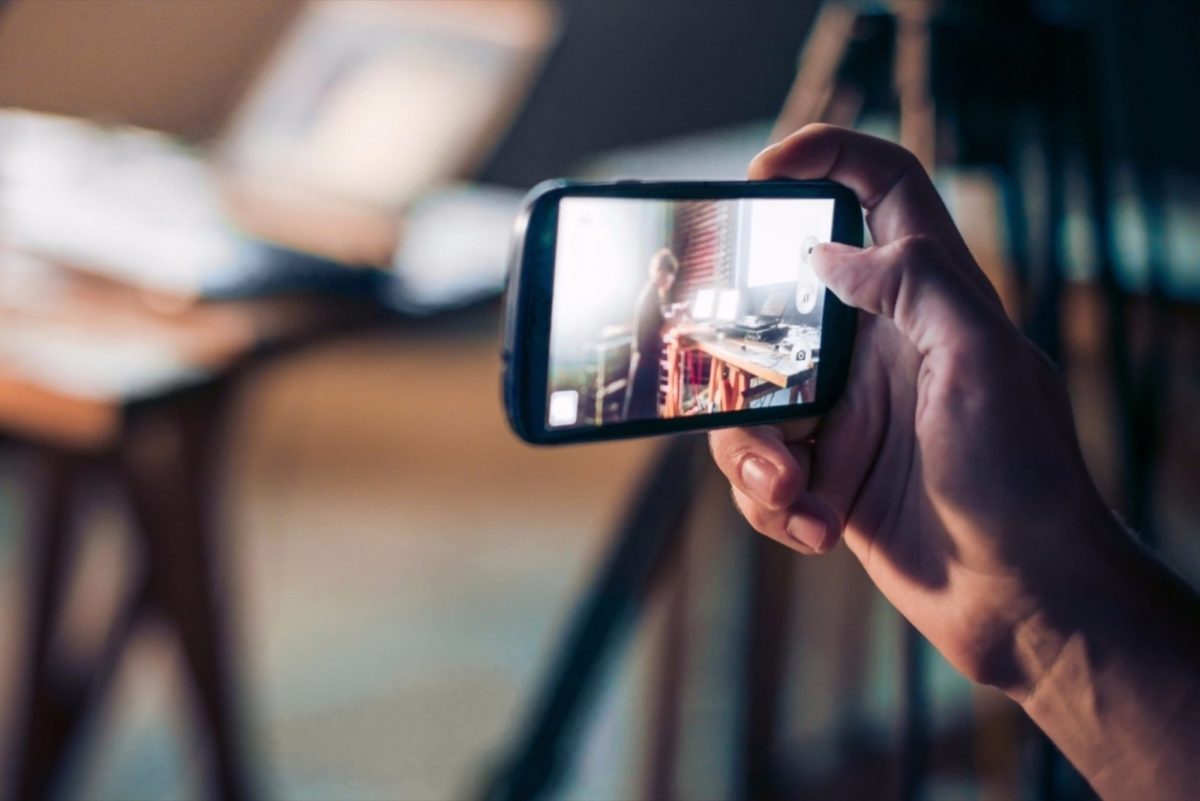 person taking a video on a mobile phone