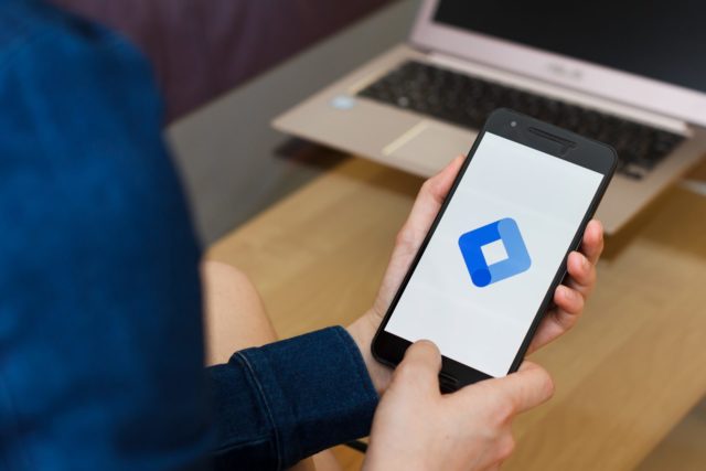 Close up of female hands holding smartphone using Google Tag Manager application