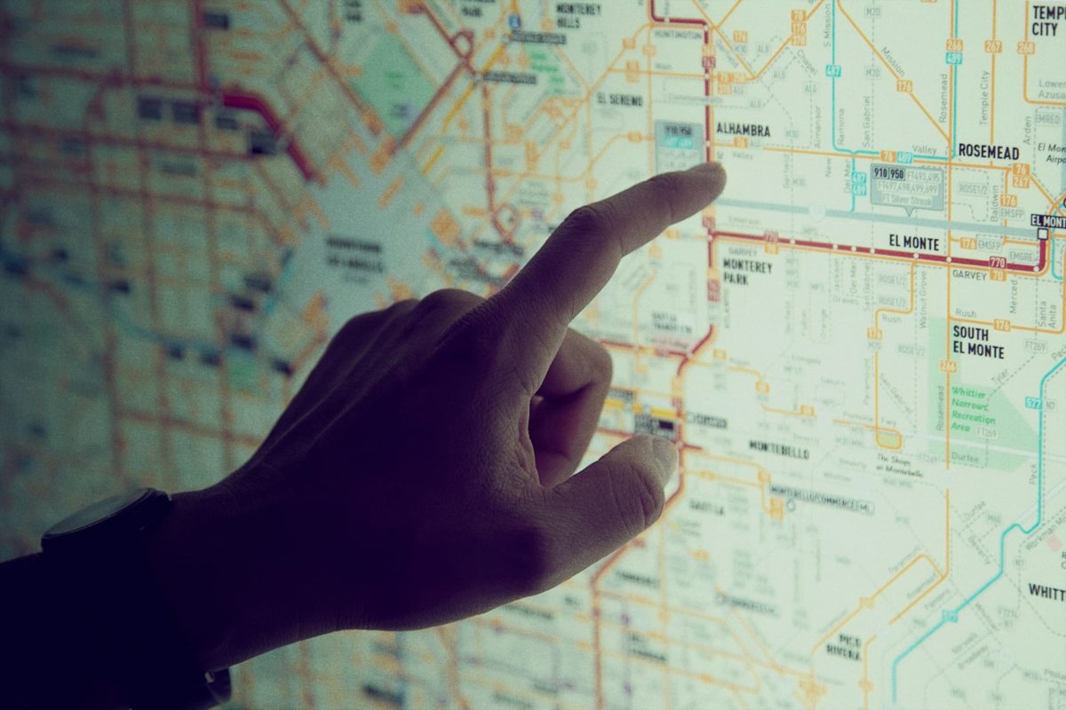 Hand pointing at a map