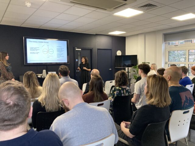 people sitting in room watching presentation