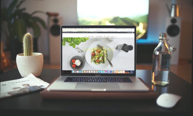 laptop on a desk with picture of avocado