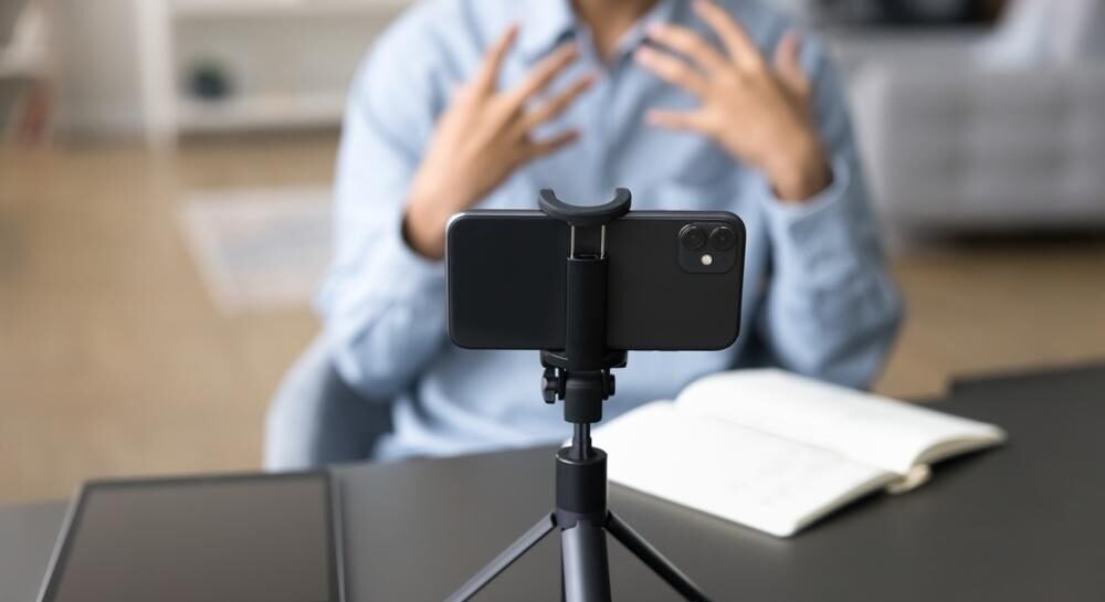 A member of staff recording a video on their mobile phone in a professional environment