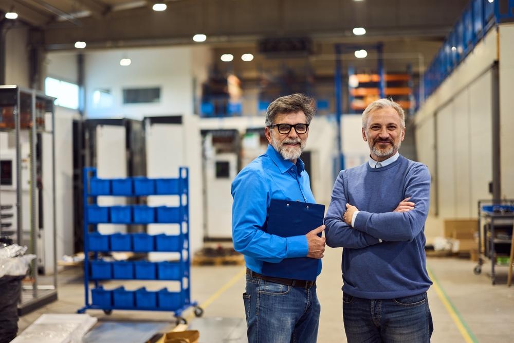Confident,Colleagues,Pose,In,A,Bright,And,Organized,Industrial,Environment