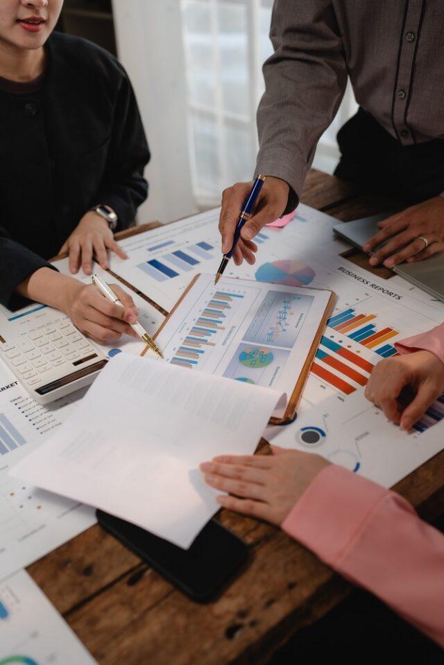 Business,Colleagues,Collaborating,On,A,Strategic,Project,,Reviewing,Financial,Graphs